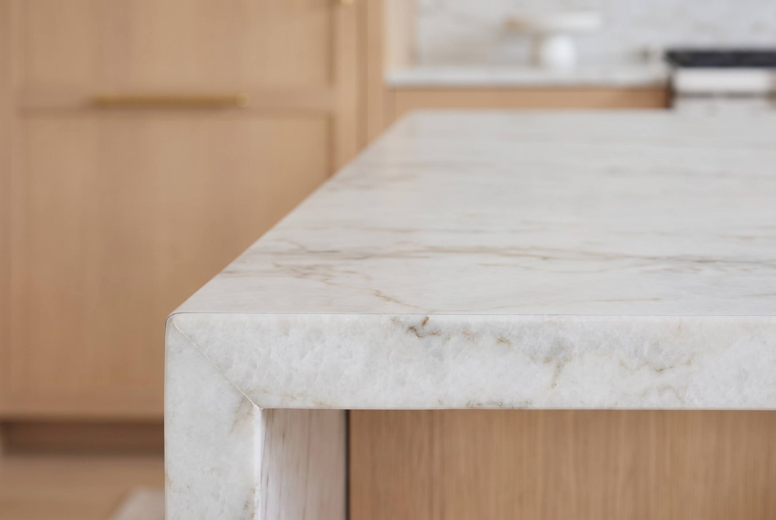 Protected quartzite island edge in NYC, showing a clean, low sheen finish with StoneGuard film.
