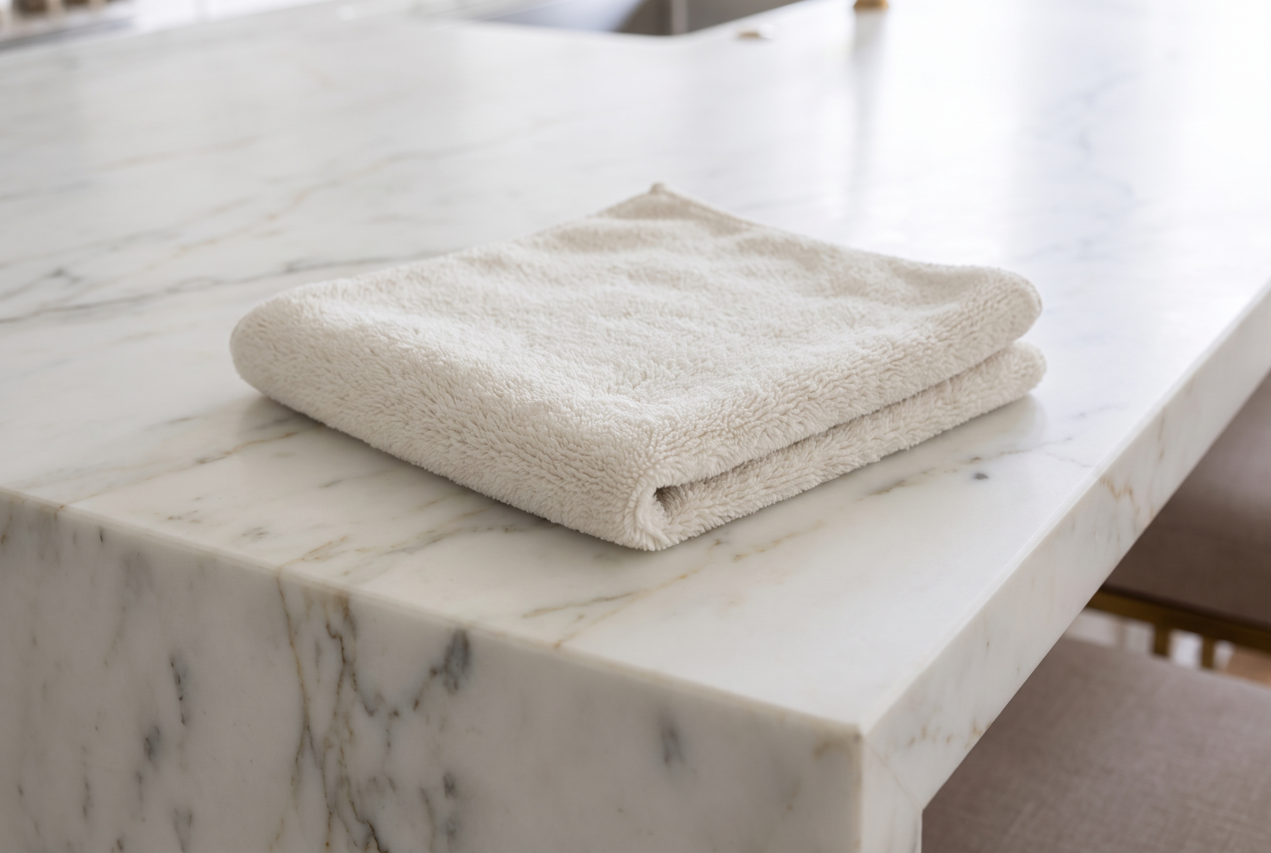 Gentle cleaning with a neutral stone cleaner and microfiber cloth on marble.