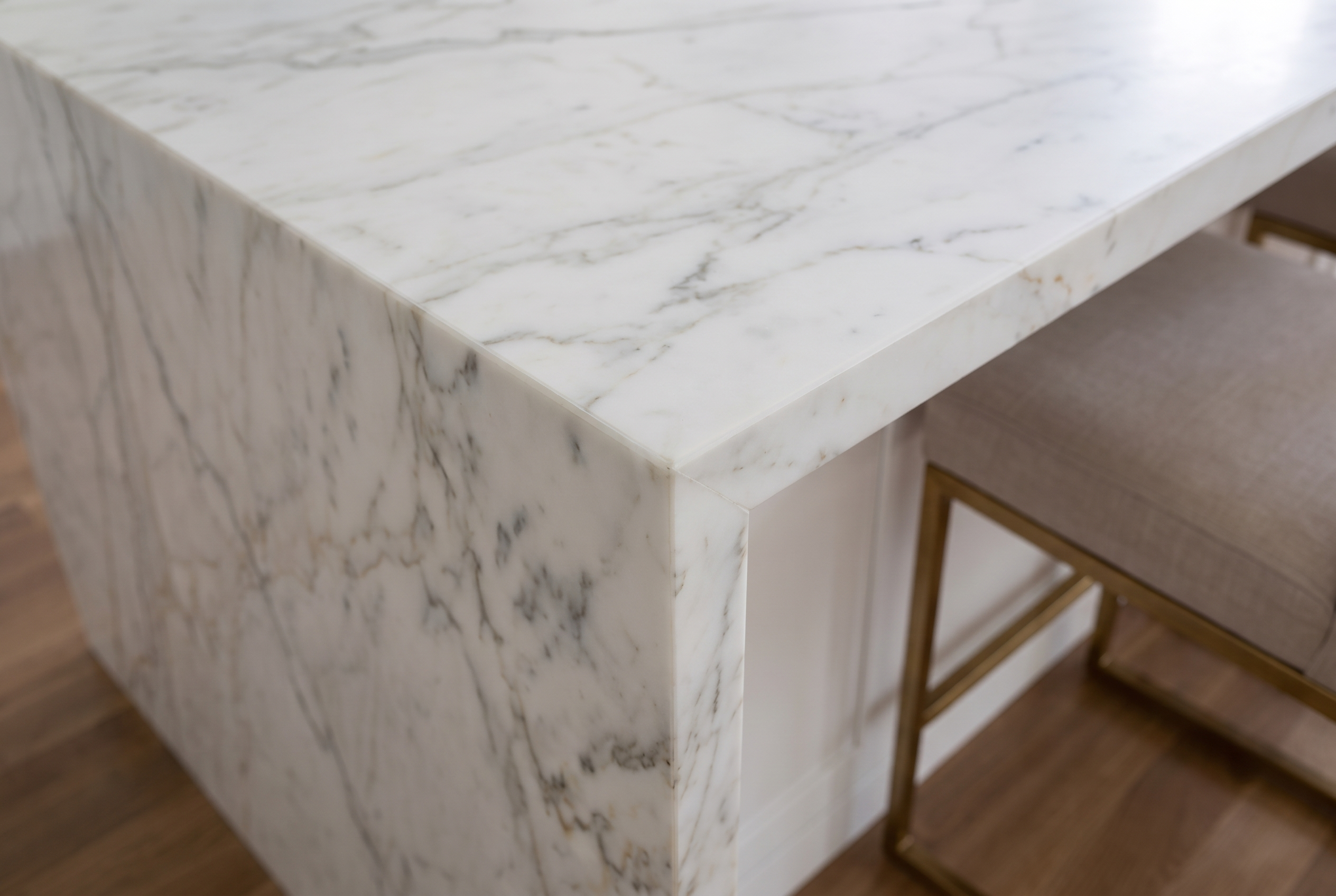 Close view of a marble island corner protected with nearly invisible StoneGuard film.