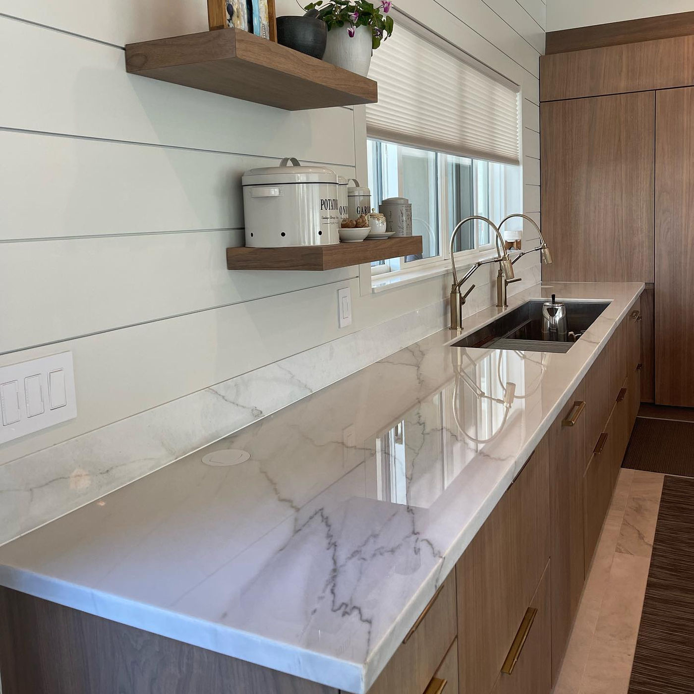 Beach house. Light stone over warm wood. Light Marble with StoneGuard Clear film in The Hamptons, NY