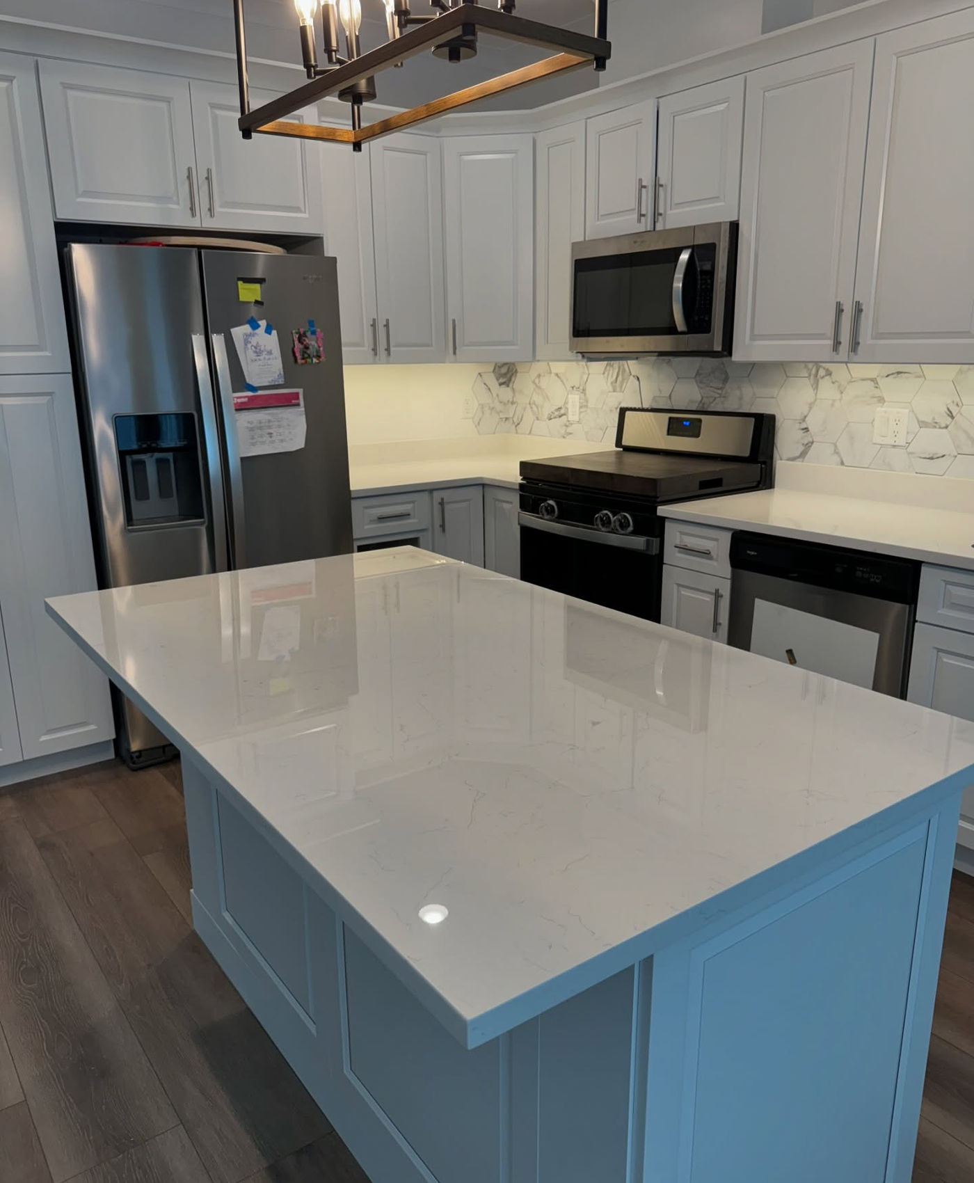 Modern quartz island and matching backsplash. Calacatta Quartz with StoneGuard Clear film in Hoboken, NJ