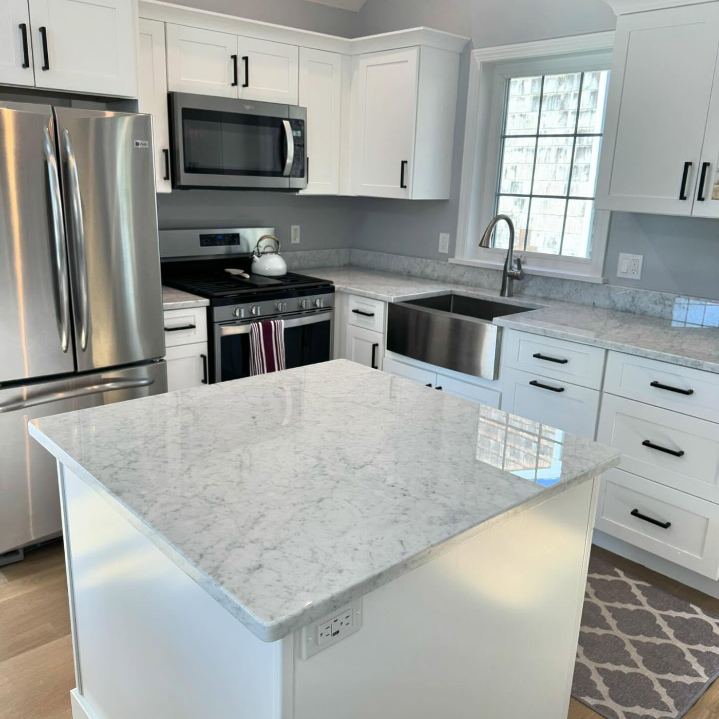 All-white kitchen, polished island and perimeter. White Marble with StoneGuard Clear film in Brooklyn, NY