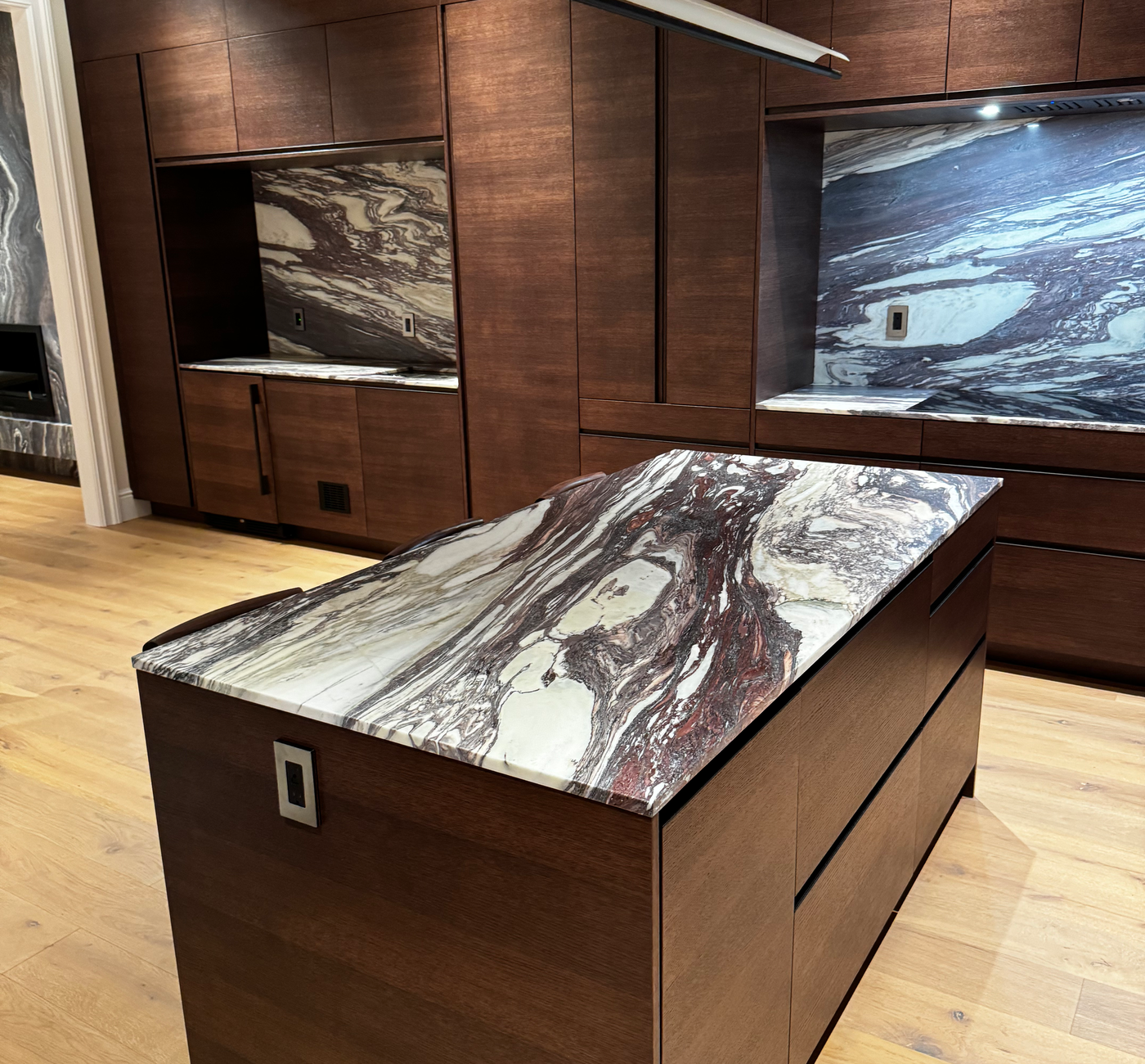 Bold burgundy veins, wood-accent kitchen. Calacatta Viola with StoneGuard Satin film in Greenwich Village, NY